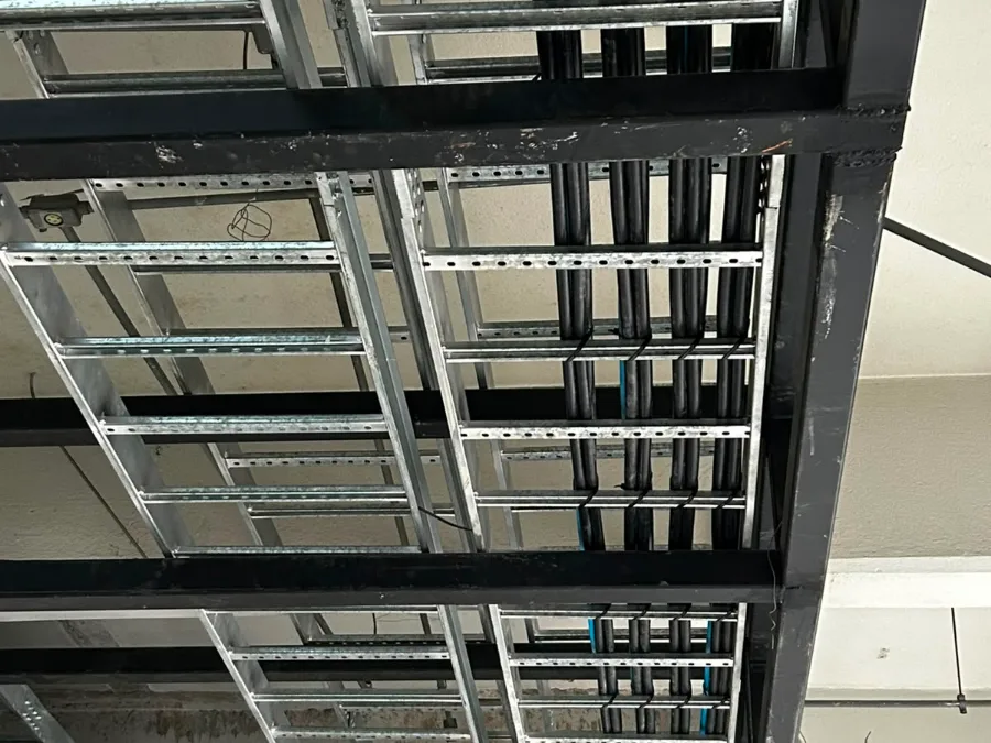Leitos e eletrocalhas em três níveis sobre estrutura metálica em data hall